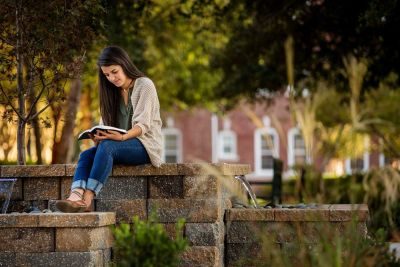 Student studying in the prayer garden on campus