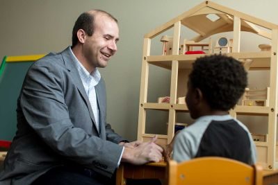 Professor James Strickland interacting with a child during a counseling session