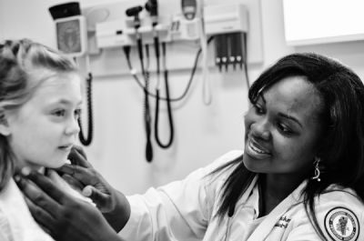 Physician assistant examining a child