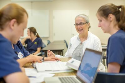 Nursing students talking with teacher
