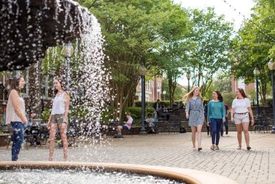 students walking near the fountain