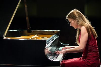 Young woman playing piano at a concert