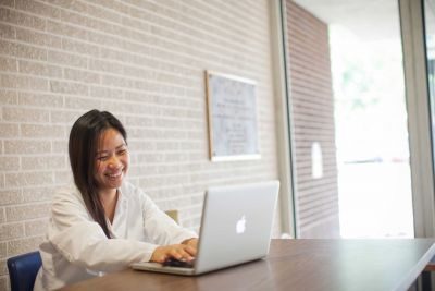 Young woman at desk with laptop 