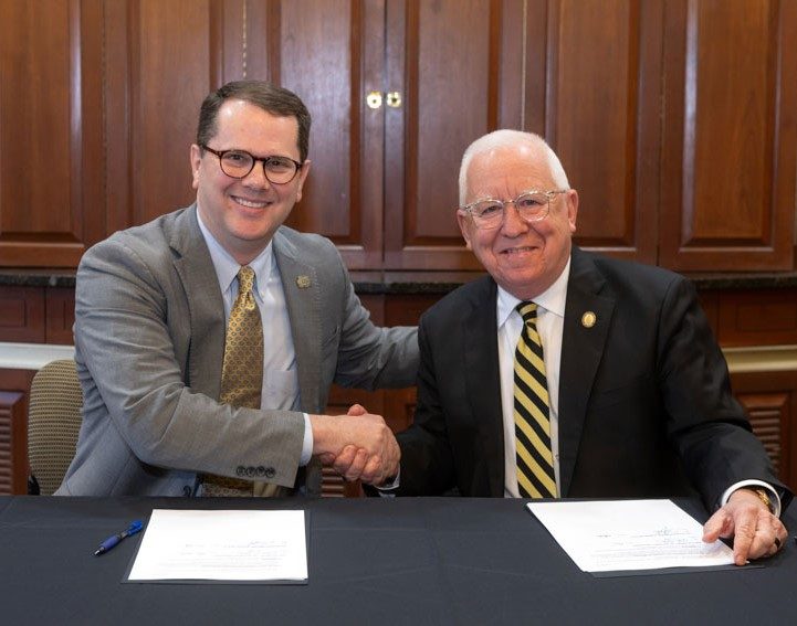 MC President Blake Thompson, left, and USM President Joe Paul congratulate one another after signing the 3+3 partnership.