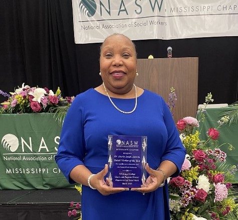 Laurie Smith Lawson displays the Social Worker of the Year Award she received from the Mississippi Chapter of the NASW.