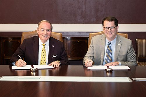 Mississippi College President Blake Thompson, right, and Mississippi State University President Mark E. Keenum sign the agreement enabling a new accelerated pathway for MSU students to enter the MC School of Law. (Photo by Beth Wynn)