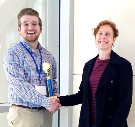 Hunter Matkins, left, receives congratulations from Dr. Lainy Day, Mississippi Academy of Sciences Neuroscience Division chair and associate professor of biology at the University of Mississippi, for earning the first-place award in the Neuroscience Division at the MAS 86th annual meeting in Biloxi.