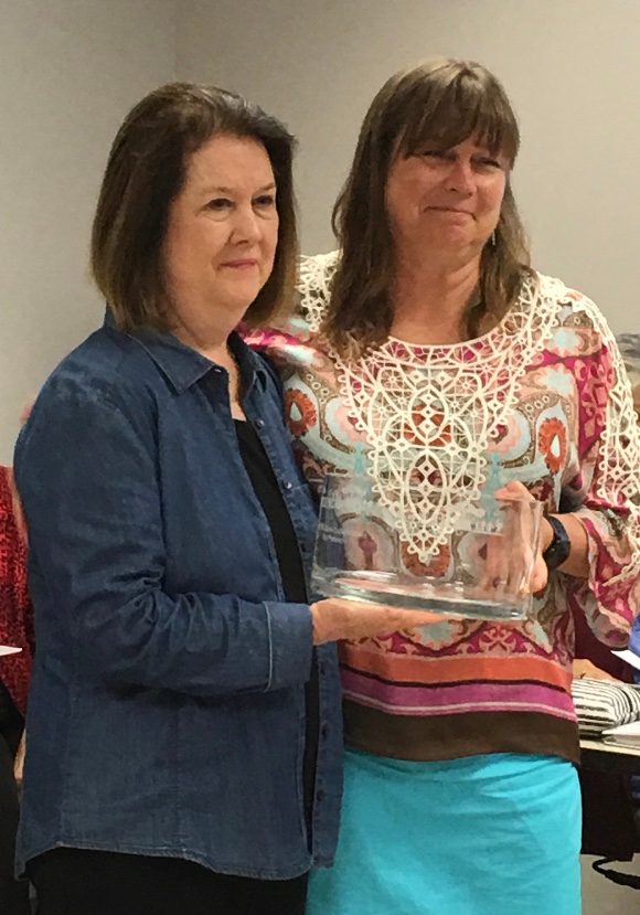 Mississippi College educator Kay Peterson (left) receives an award from organization leader Chris Bedenbaugh at a recent meeting at Middle Tennessee State University.