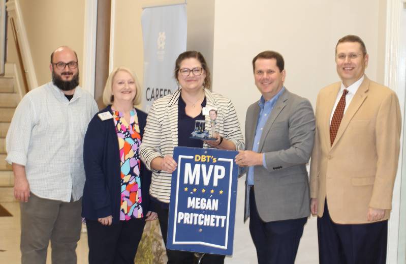 MC President Blake Thompson, second from right, flanked by Aaron Pritchett, left, director of institutional research, Cindy Hampton, second from left, information technology systems analyst, and Michael Highfield, provost and executive vice president, presents his DBT's MVP Award to Megan Pritchett, registrar.