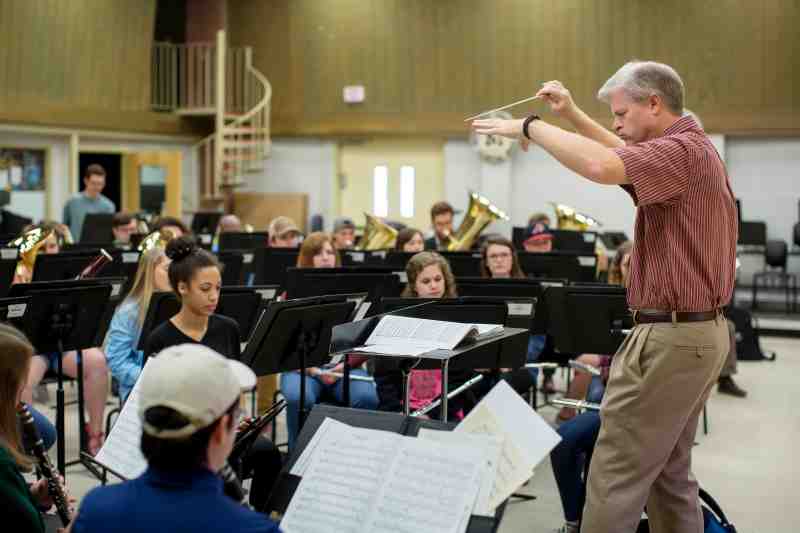 Craig Young conducts the MC Symphonic Winds orchestra.
