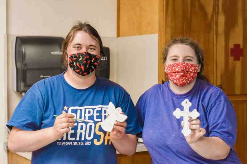 Emily Elliot, left, senior art education major from Bogue Chitto, and Cameron Huey, senior art education major from Florence, display some of the handcrafted ornaments being prepared for sale on the MC campus Nov. 29-Dec. 3.