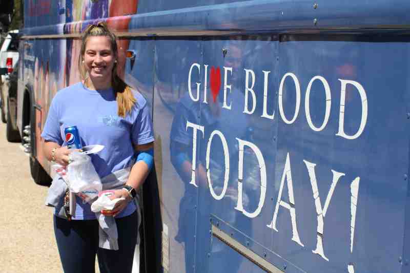 After participating in a Mississippi Blood Services drive at MC last spring, Ingrid Savola enjoys a snack and holds the MBS T-shirt she received for donating blood.