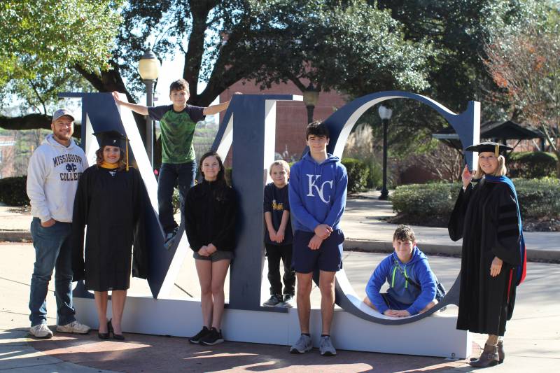 Shortly after their overnight journey to Clinton, the Buntin family, from left, Chris, Ashlea, Riley, Aubrey, Caden, Dakota, and Christian, were treated to a tour of the Mississippi College campus by Debbie Norris, MC associate provost, graduate school dean, and Ashlea’s faculty advisor.