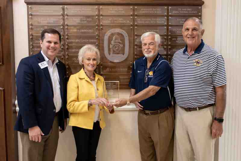 Joe D. Robison Jr., second from right, and his wife, Alice, hold the plaque they received for joining Mississippi College's exclusive 1826 Society. Helping celebrate their accomplishment are Dr. Blake Thompson, left, MC president, and Coach Mike Jones, former MC athletic director and head basketball coach.