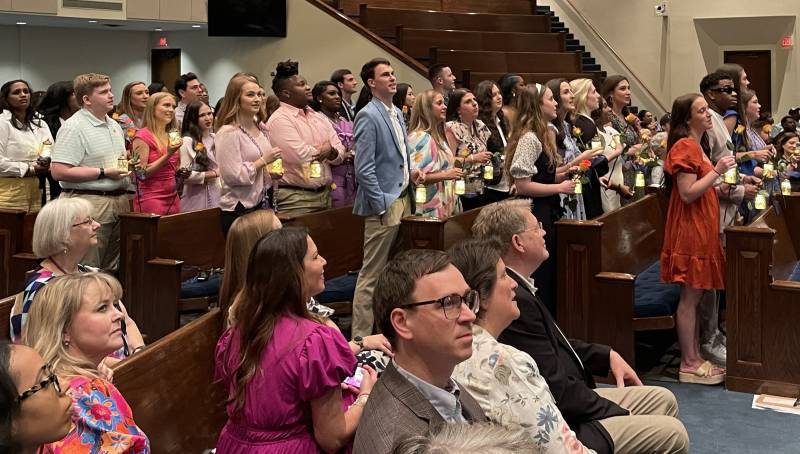 School of Nursing graduates receive pins emblematic of their transition to healthcare practitioners.