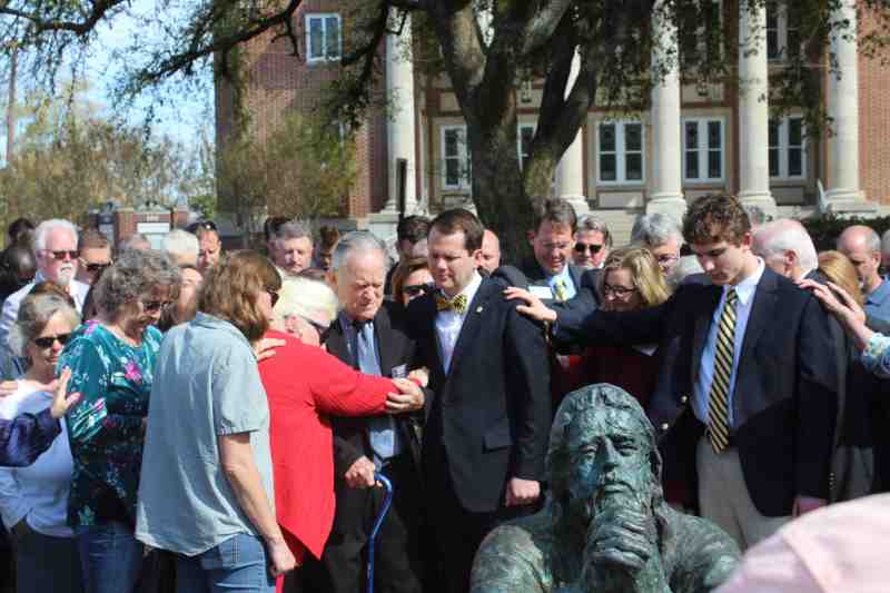 President Blake Thompson, sculptor Sam Gore and others prayed at Friday's ceremony at Mississippi College to reveal Dr. Gore's latest piece of art 