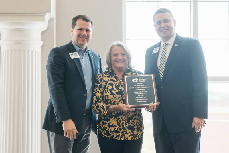 MC President Blake Thompson, left, and Michael J. Highfield, MC provost and executive vice president, confer the title of Assistant Professor of Nursing Emerita upon Susan Richardson during MC's Convocation.