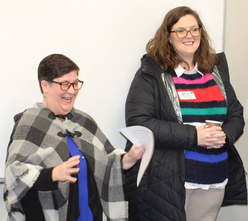 Amy Williamson, left, associate professor and chair of the Department of Modern Languages, and Ashley Krason, assistant professor in the Department of Modern Languages, enjoy reminiscing about their longtime colleague, Emily Fokeladeh, during the ceremony in Jennings Hall.  
