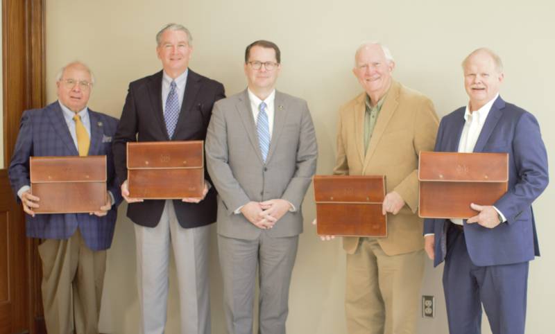 MC President Blake Thompson, center, congratulates outgoing members of the MC Board of Trustees on their service: from left, Ralph Barnes, Dr. Ronnie Falvey, Roy Fountain, and Rev. Hugh Plunkett.