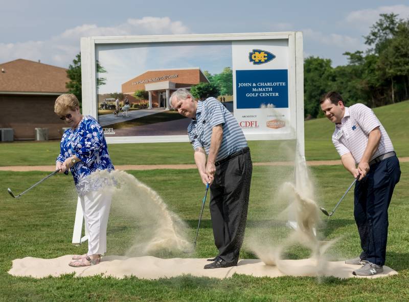 MC President Blake Thompson, right, joins John and Charlotte McMath in a ceremonial bunker shot to 'break sand' for the state-of-the-art golf practice facility that will bear the couple's name.