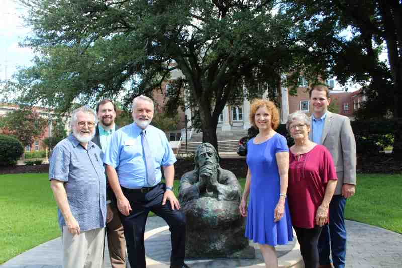 A $1,000 gift from the Clinton Arts Council helps support the late Sam Gore's Christ in Gethsemane sculpture. Unveiled in late March, the sculpture was completed about a month prior to Dr. Gore's passing in April. Clinton Arts Council President Bob Blanton, art professor Ray Gregory and Art Department Chair Randy Miley are pictured July 12 at the sculpture in the Rhoda Royce Prayer Garden. Gore family members: Dr. Judy Gore Gearhart and Joedda Gore, both of Clinton. They are joined by MC President Blake Thompson. Fund raising efforts continue at MC, where Dr. Gore served as the Founding Father of the Christian university's Art Department in the 1950s.
