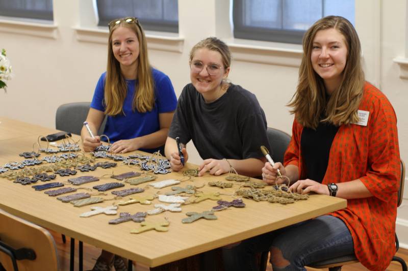 Art education students, from left, Zoe Bushway, Kate Sennett, and Kendall Mackey enjoy crafting ornaments for sale to help send senior students to the NAEA annual meeting.