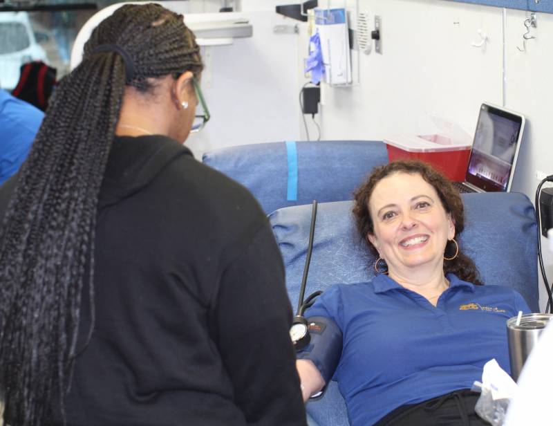 Ferren Foster, left, donor tech II with Mississippi Blood Services, draws a donation from Ellen Vinzant, office manager in the Office of Public Safety, on the MBS donor bus during this year's first spring blood drive at MC.