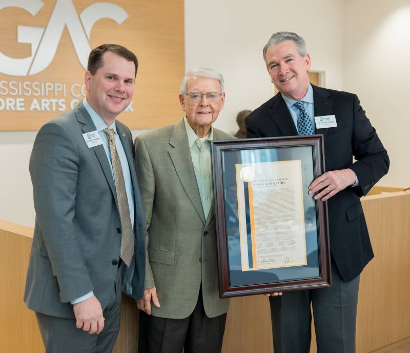 During the Board of Trustees meeting Dec. 14, MC President Blake Thompson, left, and Ronnie Falvey, right, chair, MC Board of Trustees, present a citation to Frank Gunn and inform him that the new ministerial scholarship competition will be named in his honor.