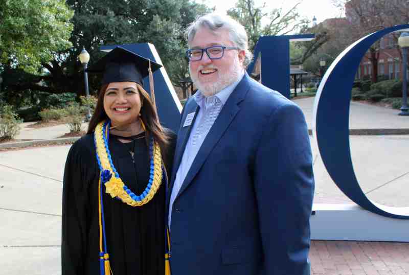 New Mississippi College graduate Rodalyn Gerardo of Guam is joined by her MC advisor, accounting professor Billy Morehead on her commencement day, December 20, 2019.