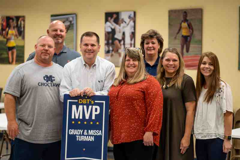 Dr. Blake Thompson, third from left, presents the DBT's MVP Award for August 2022 to Grady Turman, left, and Missa Turman, center, in the Quick Rebounders Room. On hand for the presentation are, from left, Kenny Bizot, MC athletic director; Susan Musselwhite, MC associate athletic director for compliance; Mandy Phillips, Baptist Student Union director and DBT’s MVP for June 2022; and Marcy Hutton, assistant compliance officer and academic advisor in the Athletic Department.