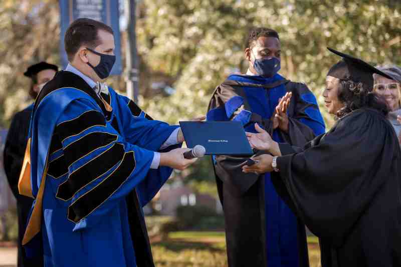 President Blake Thompson presents Maggie Wade with her Mississippi College diploma at Thursday's special commencement honoring the outstanding WLBT-TV 3 news anchor.