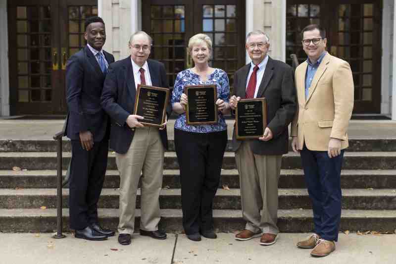Dr. Blake Thompson, right, Mississippi College president, and Dr. Keith Elder, left, MC provost and executive vice president, congratulate the Christian University's newest slate of emeritus selections. Among them are H. Lee Hetherington, second from left, professor emeritus of law; Donna Lewis, chief financial officer emeritus; and Leland 