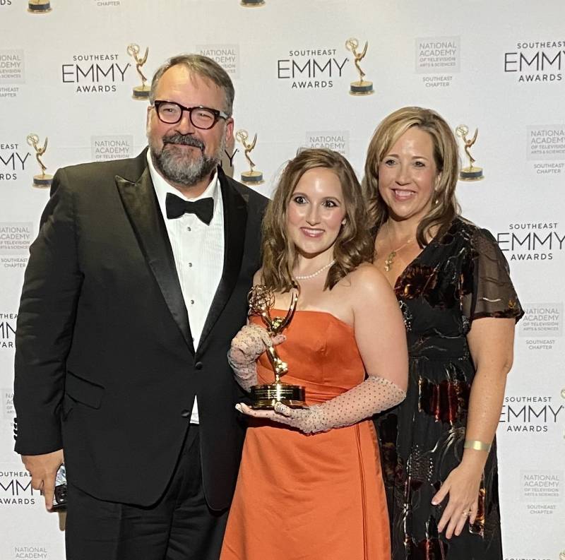 Flanked by her parents, Anthony and Amy Thaxton, Sydney Thaxton displays the 2025 Southeast EMMY Award she received for her work on the documentary film, 