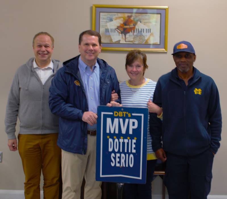 Congratulating Dottie Serio on receiving the February DBT's MVP are, from left, Ben Williams, professor and chair of the MC Department of Music; MC President Blake Thompson, and Alfred Daniels, set-up foreman and previous DBT's MVP selection.