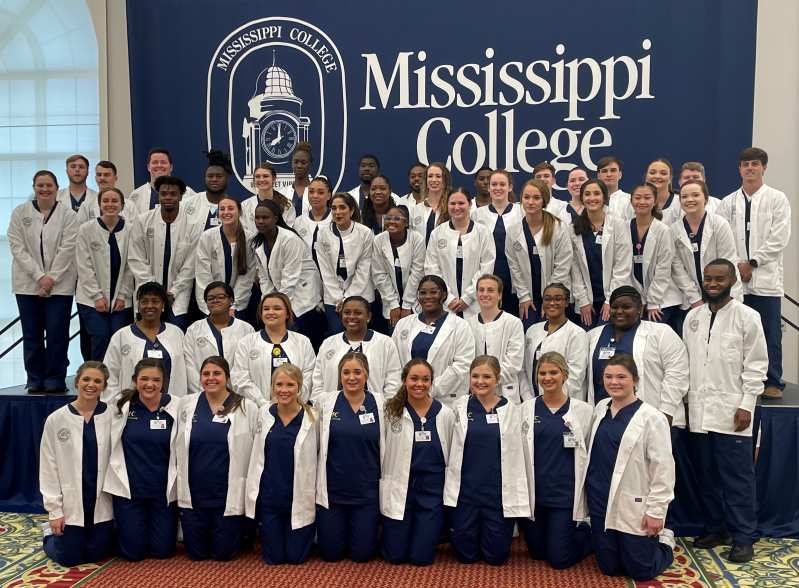 School of Nursing students display their new white coats following the ceremony in the B.C. Rogers Student Center.   
