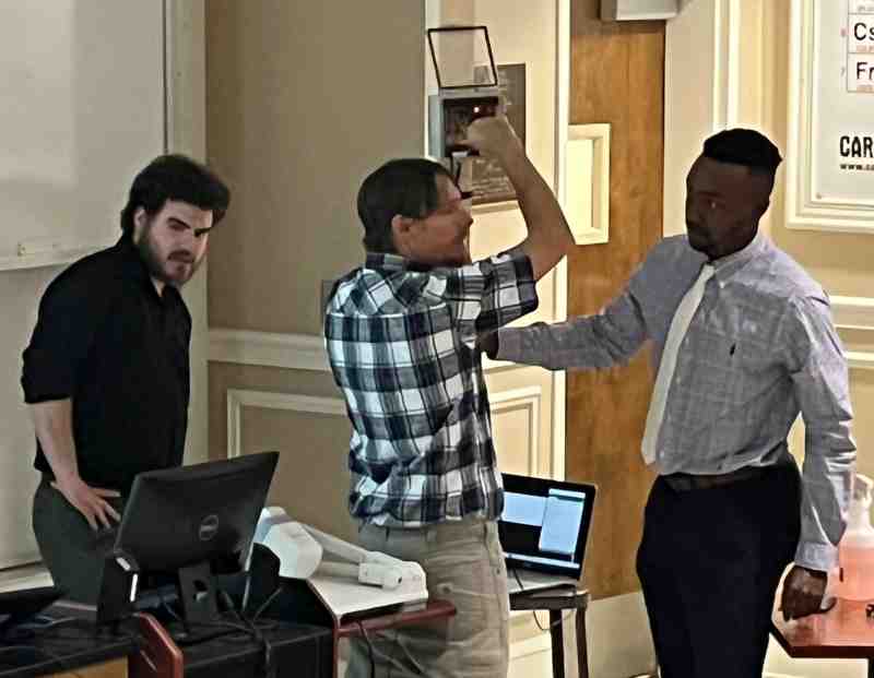 Senior students in the Electrical Engineering Program, from left, Zac Boudoin, Zach Crandell, and Kenneth Scott, demonstrate their automatic water sensor project.