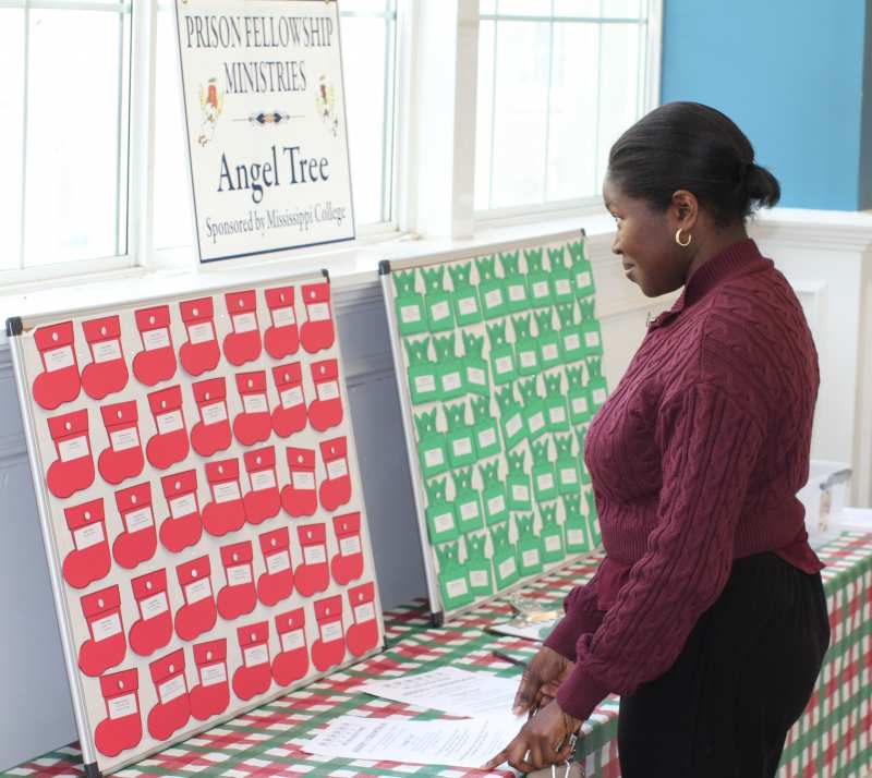 Britney Young, a senior psychology major from Jackson, peruses the Angel Tree table in the Caf Nov. 14.