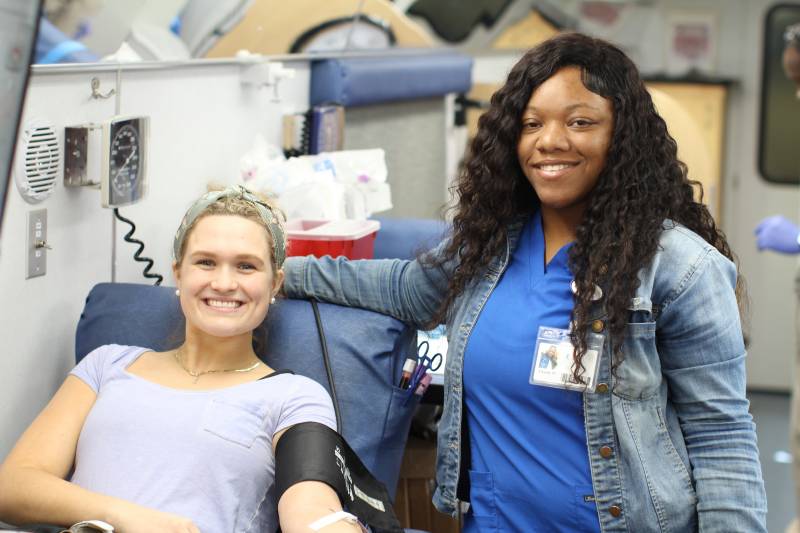 Isabella Dart, left, discusses the donation process with Chasity Walker, Mississippi Blood Services donor technician, before giving blood.